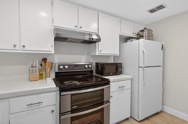 a kitchen with cabinets and appliances