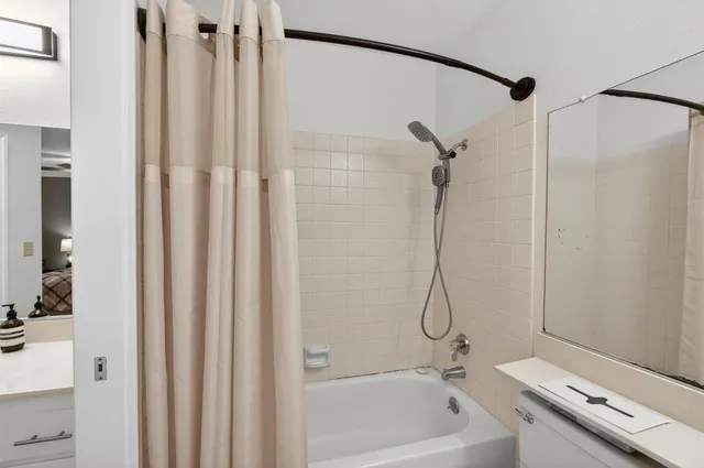 a bathroom with a bath tub with a shower