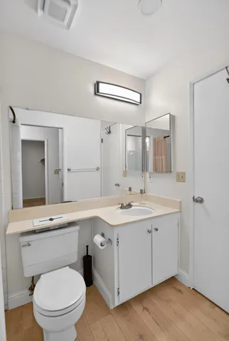 a bathroom with a toilet a sink and mirror