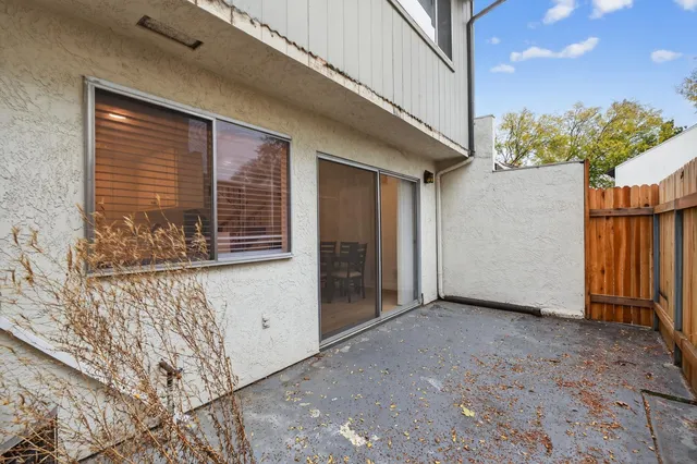 a view of a house with wooden fence