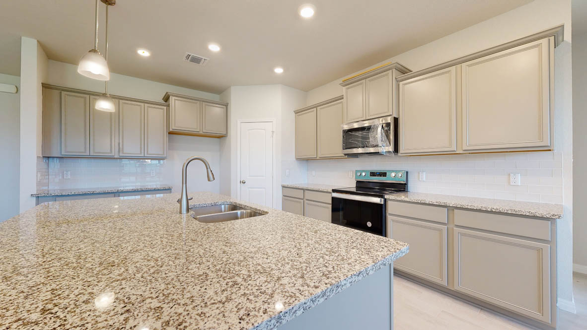 808 Gauge Road Thorndale, TX 76577 - Photo 3 of 31 A well-appointed kitchen features a large central island and ample cabinetry, ready for culinary endeavors.
