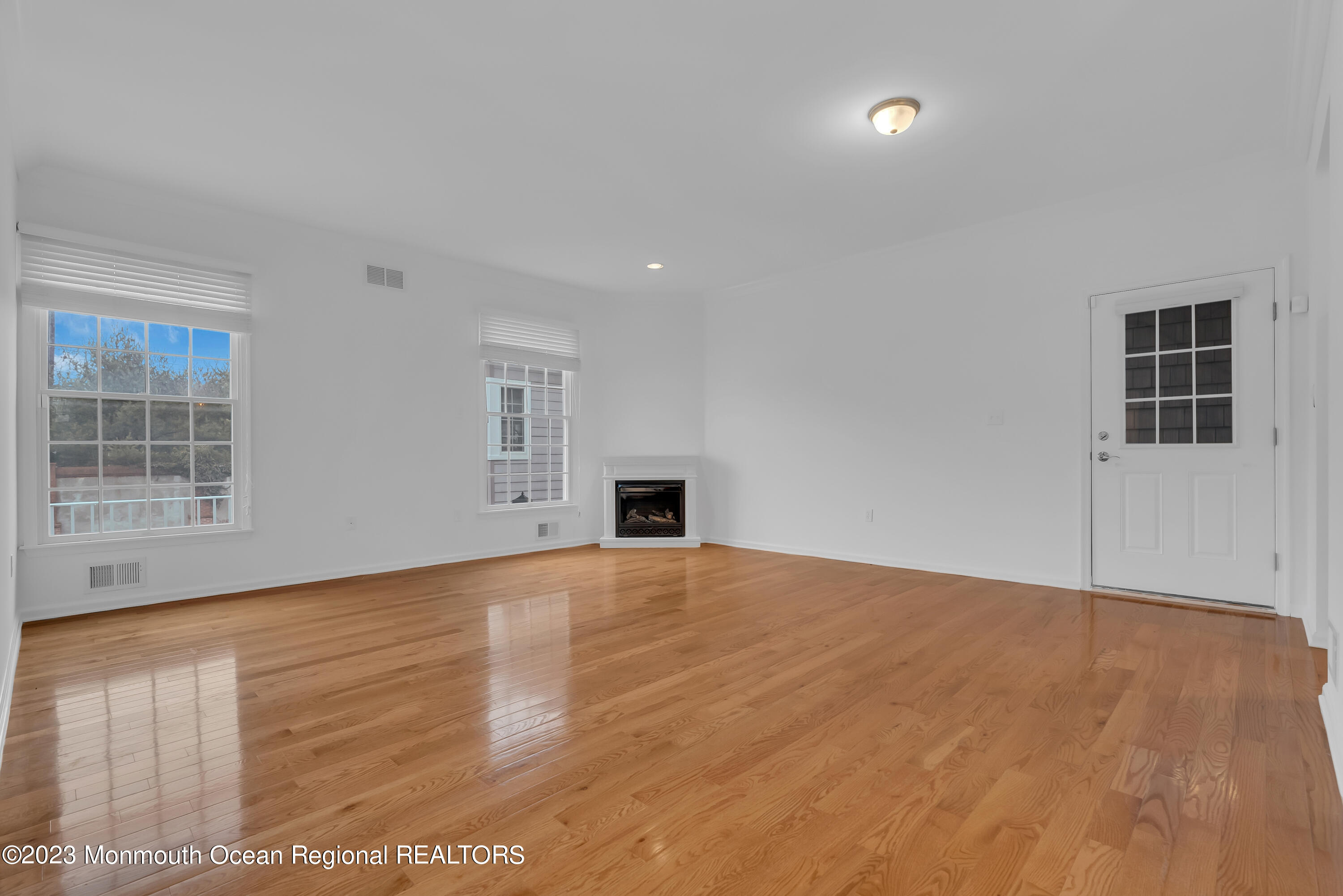 16 Mariners Bend Brielle, NJ 08730 - Photo 11 of 66 a view of an empty room with wooden floor and a window