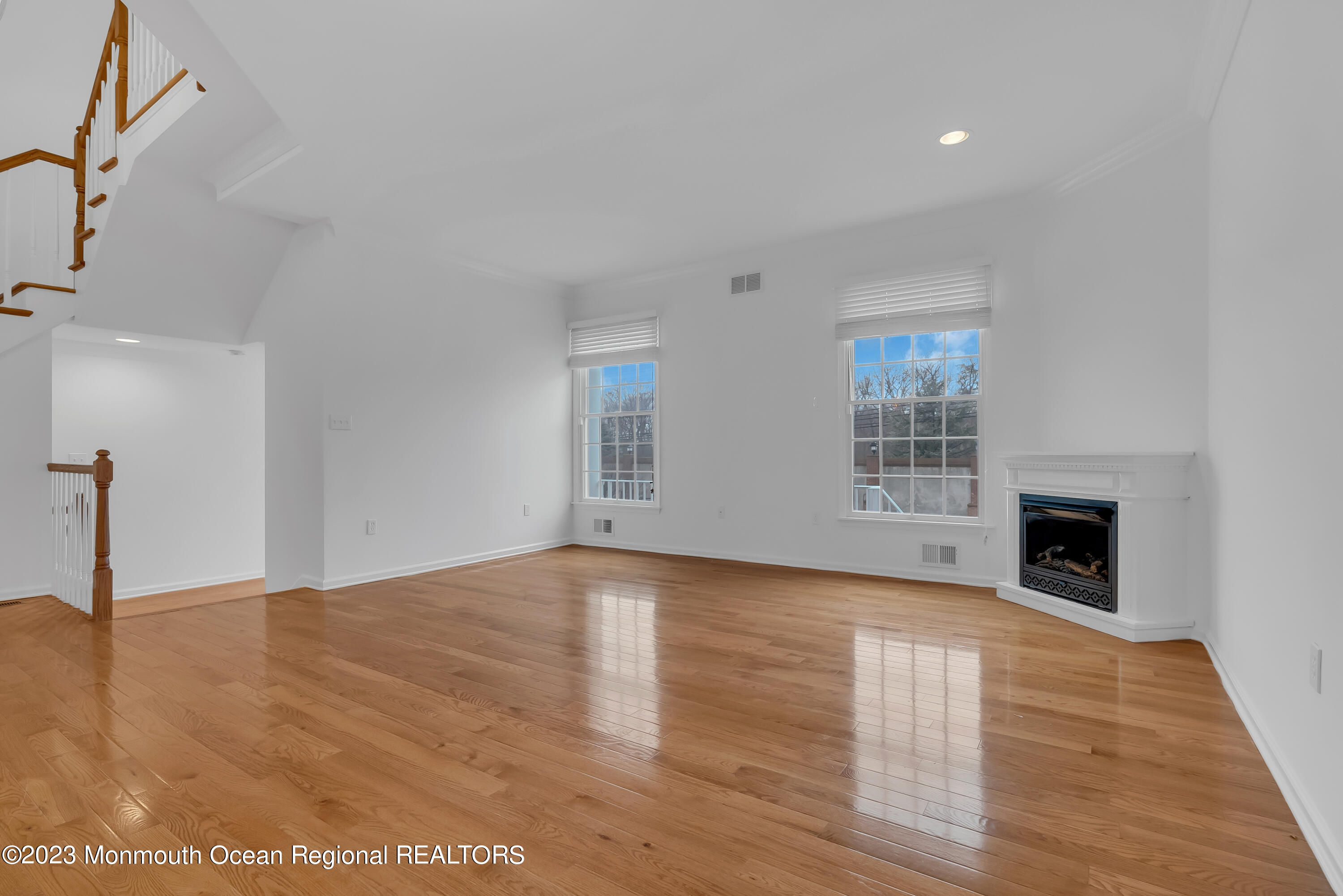 16 Mariners Bend Brielle, NJ 08730 - Photo 12 of 66 a view of an empty room with wooden floor fireplace and a window