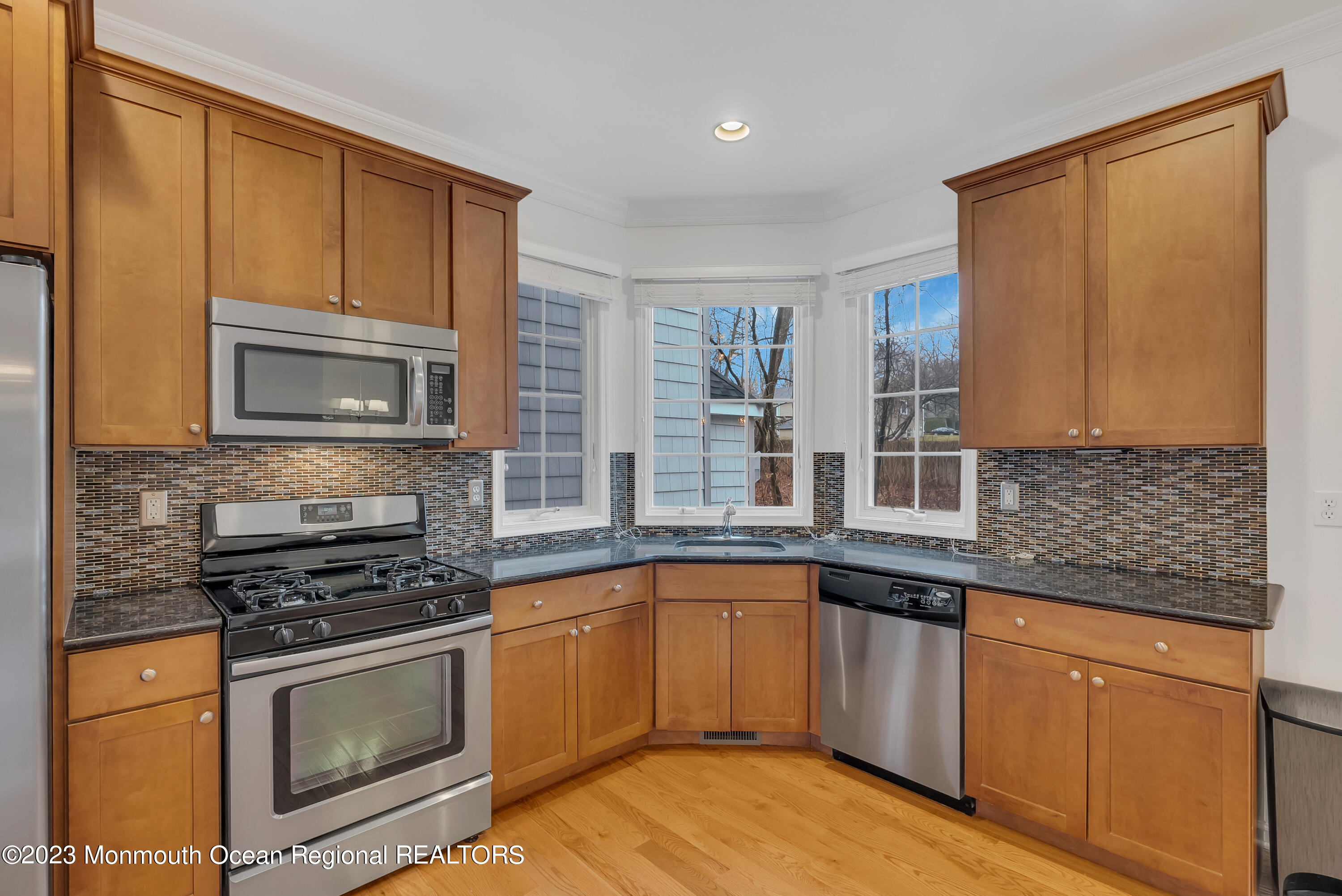 16 Mariners Bend Brielle, NJ 08730 - Photo 18 of 66 a kitchen with granite countertop a sink stove and microwave