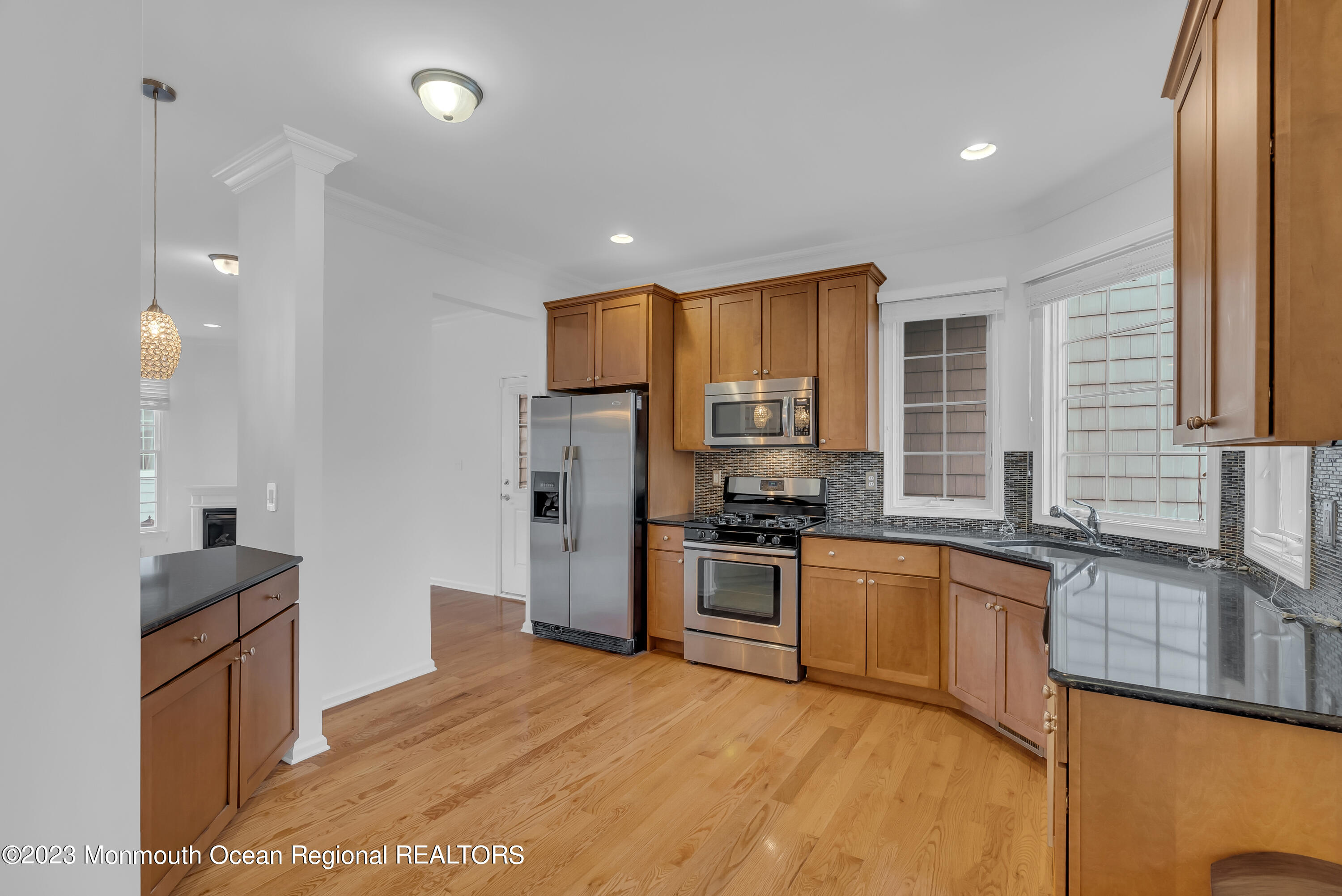 16 Mariners Bend Brielle, NJ 08730 - Photo 19 of 66 a kitchen with stainless steel appliances granite countertop a refrigerator a sink dishwasher a stove with wooden cabinets and floor
