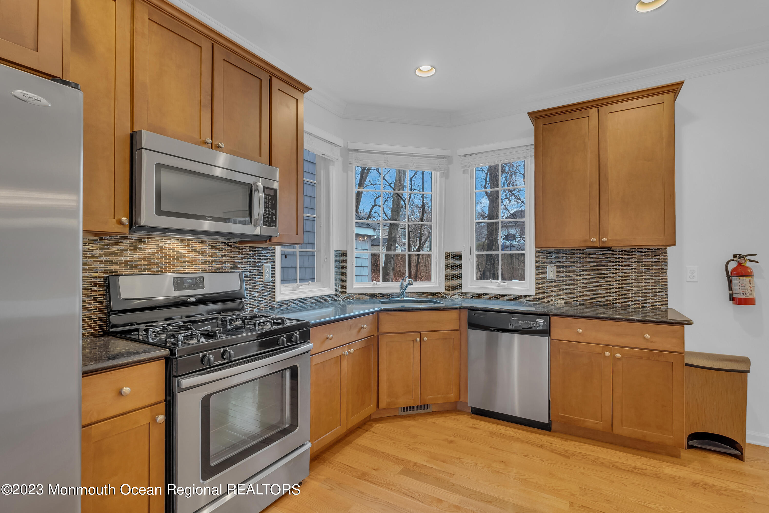 16 Mariners Bend Brielle, NJ 08730 - Photo 20 of 66 a kitchen with granite countertop wooden cabinets stainless steel appliances and a counter space