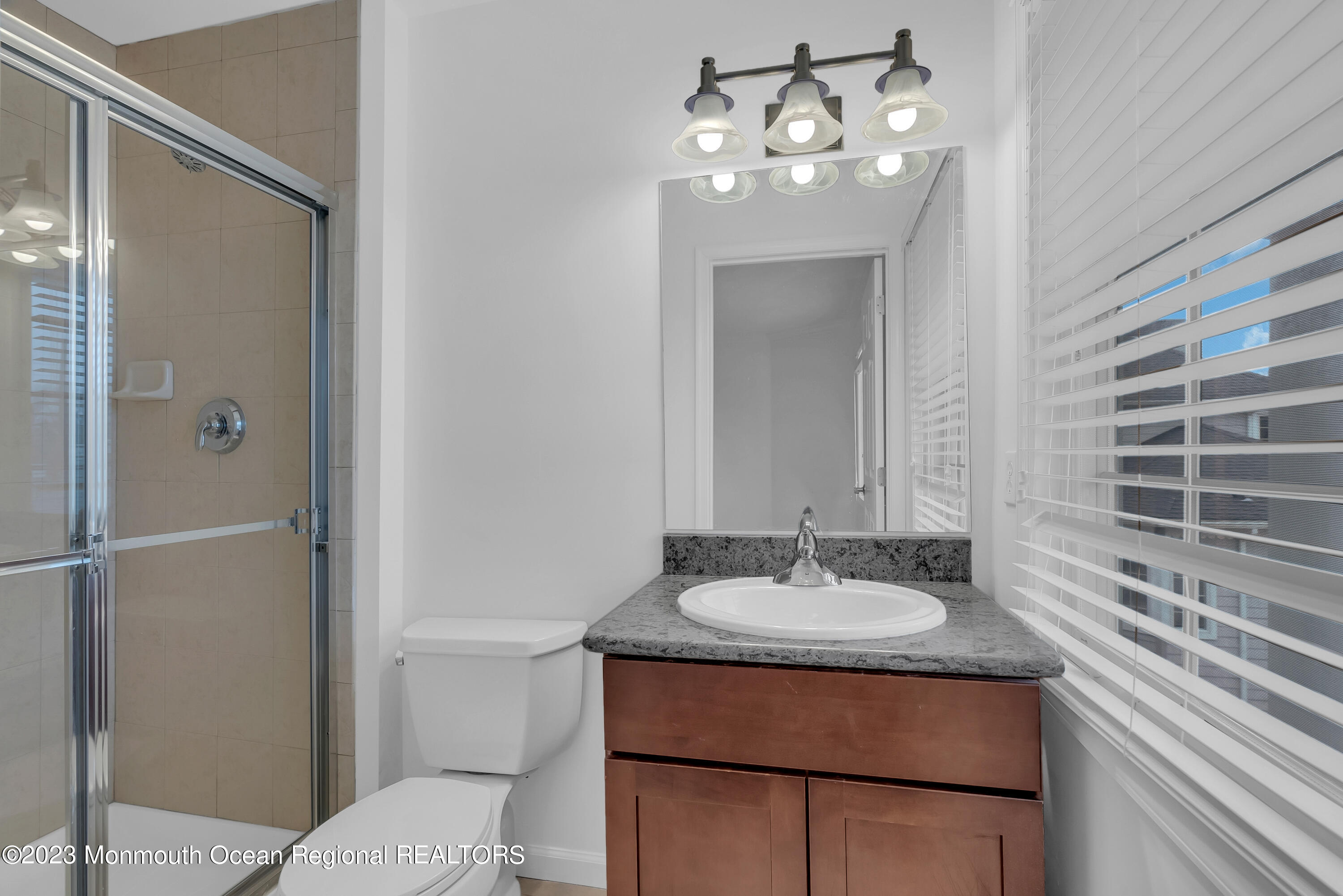 16 Mariners Bend Brielle, NJ 08730 - Photo 29 of 66 a bathroom with a sink vanity granite and a mirror
