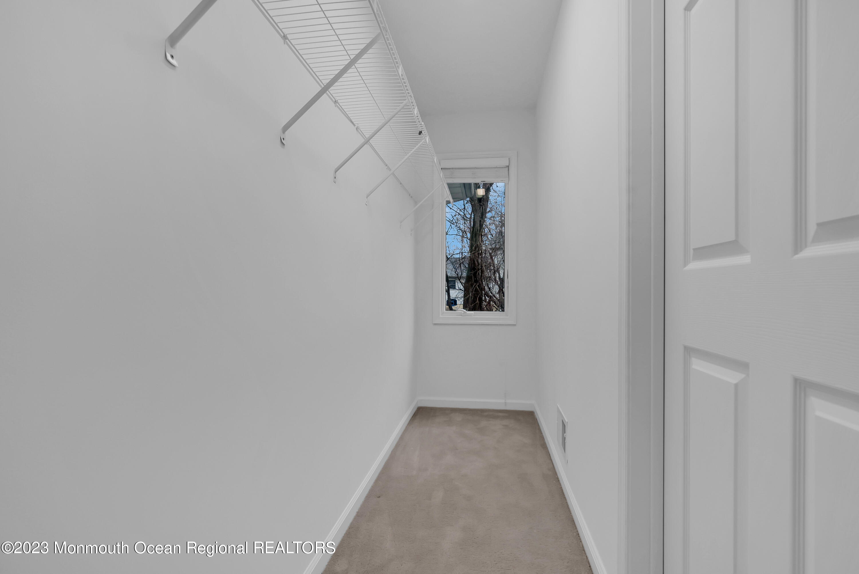 16 Mariners Bend Brielle, NJ 08730 - Photo 36 of 66 a view of a hallway with wooden floor and a white wall