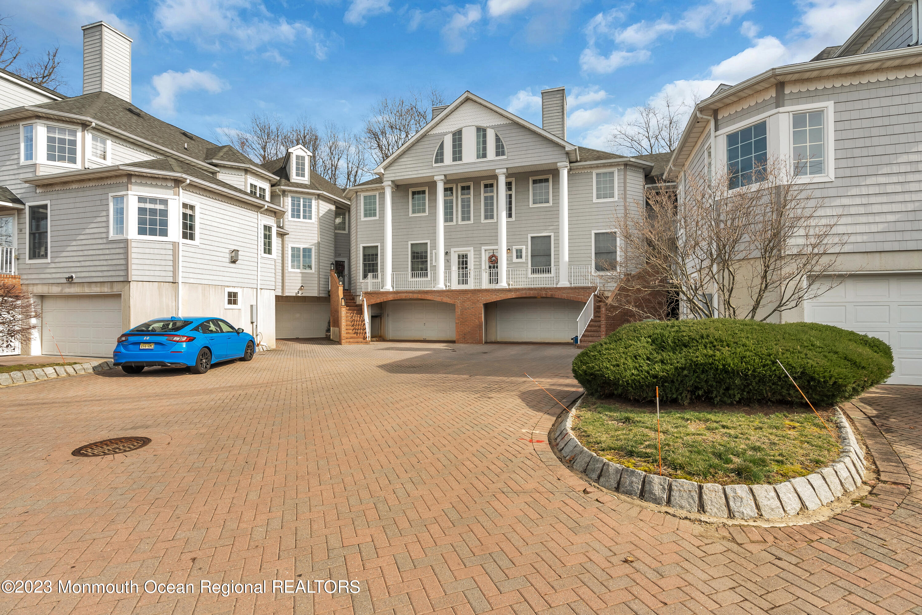 16 Mariners Bend Brielle, NJ 08730 - Photo 54 of 66 a view of a white house with a yard and potted plants