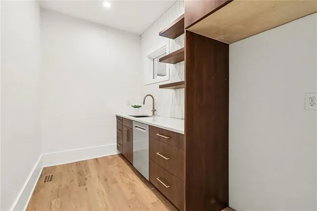 a view of a hallway with paintings on the wall