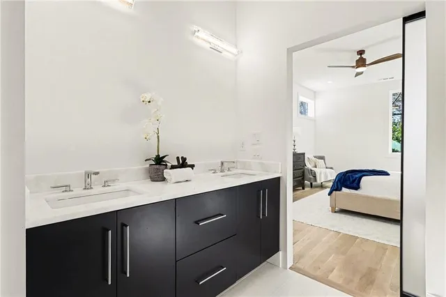 an empty room with a window and a ceiling fan