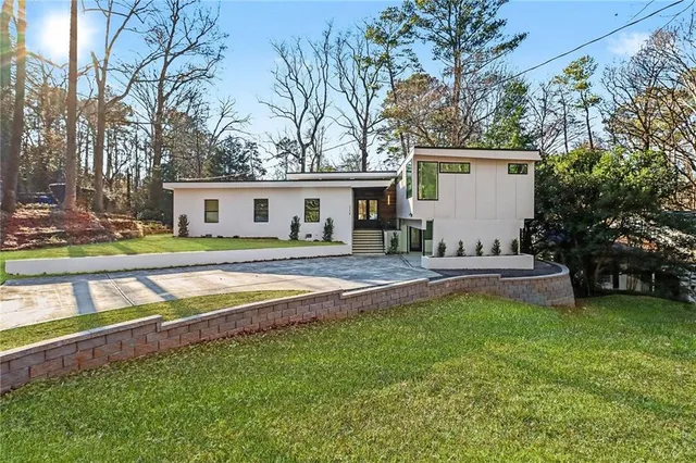 a view of a house with a yard and sitting area