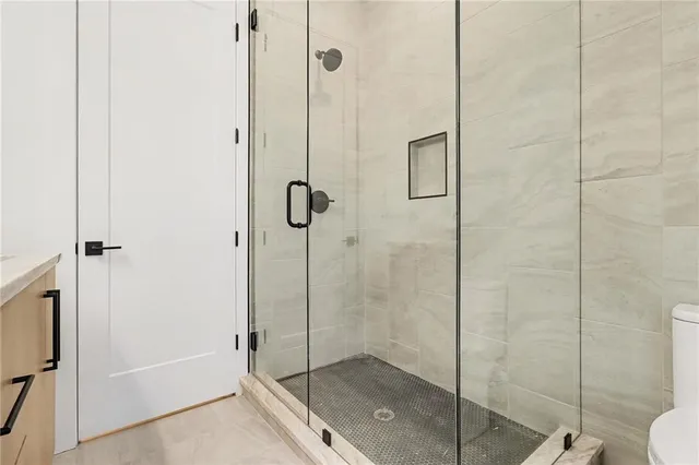 a view of a big room with windows fire place and backyard