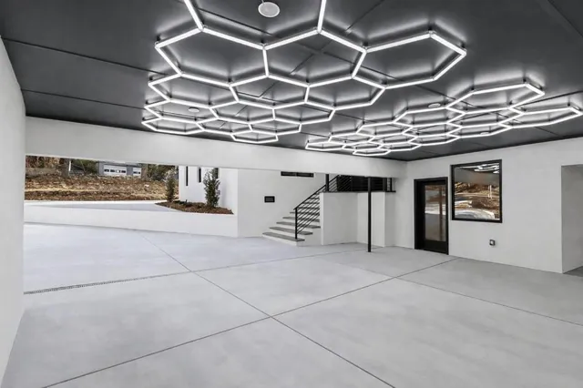 a kitchen with stainless steel appliances granite countertop a stove a sink dishwasher and a refrigerator with wooden floor