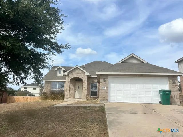 a front view of a house with yard