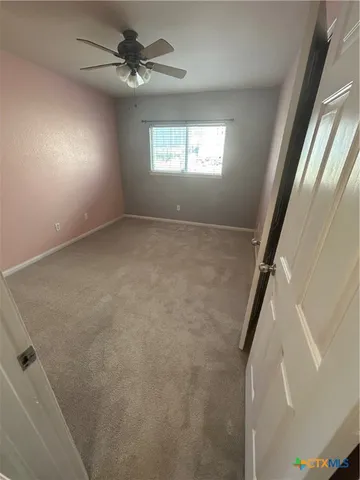 a view of an empty room with a fireplace