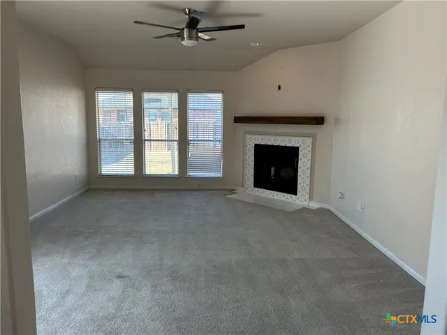 a kitchen with a refrigerator a sink and wooden floor