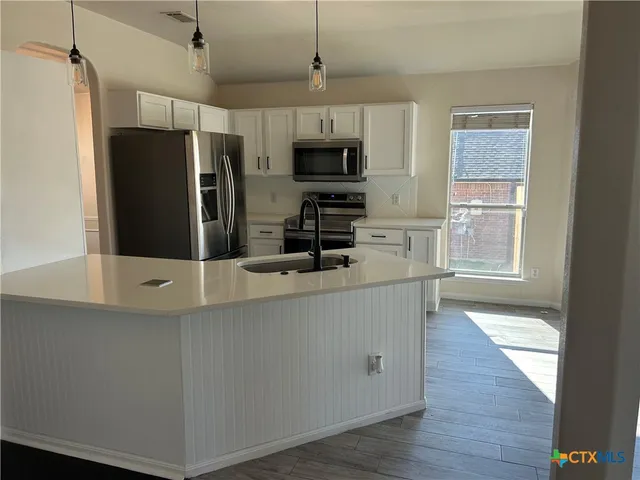 a room with wooden floors and white walls