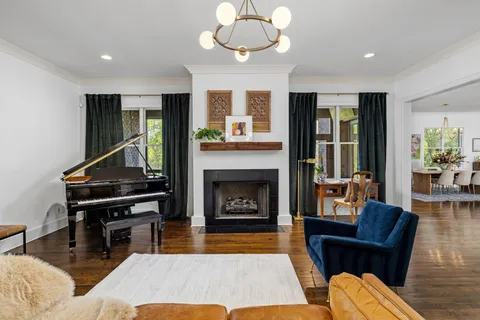 a large kitchen with stainless steel appliances granite countertop a stove and a wooden floors