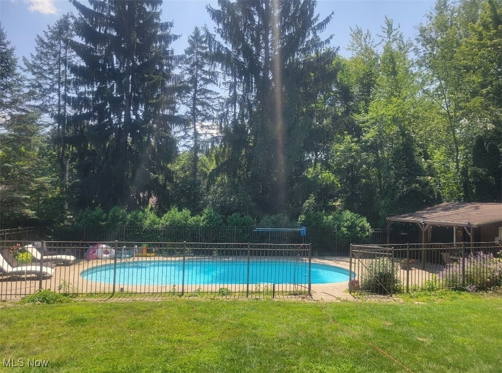 View of in-ground swimming pool with a fenced in yard