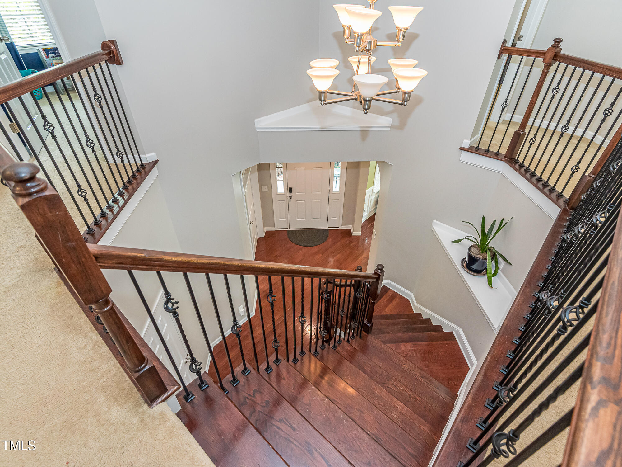 111 Gathering Place Durham, NC 27713 - Photo 35 of 44 a view of staircase with wooden floor and a chandelier