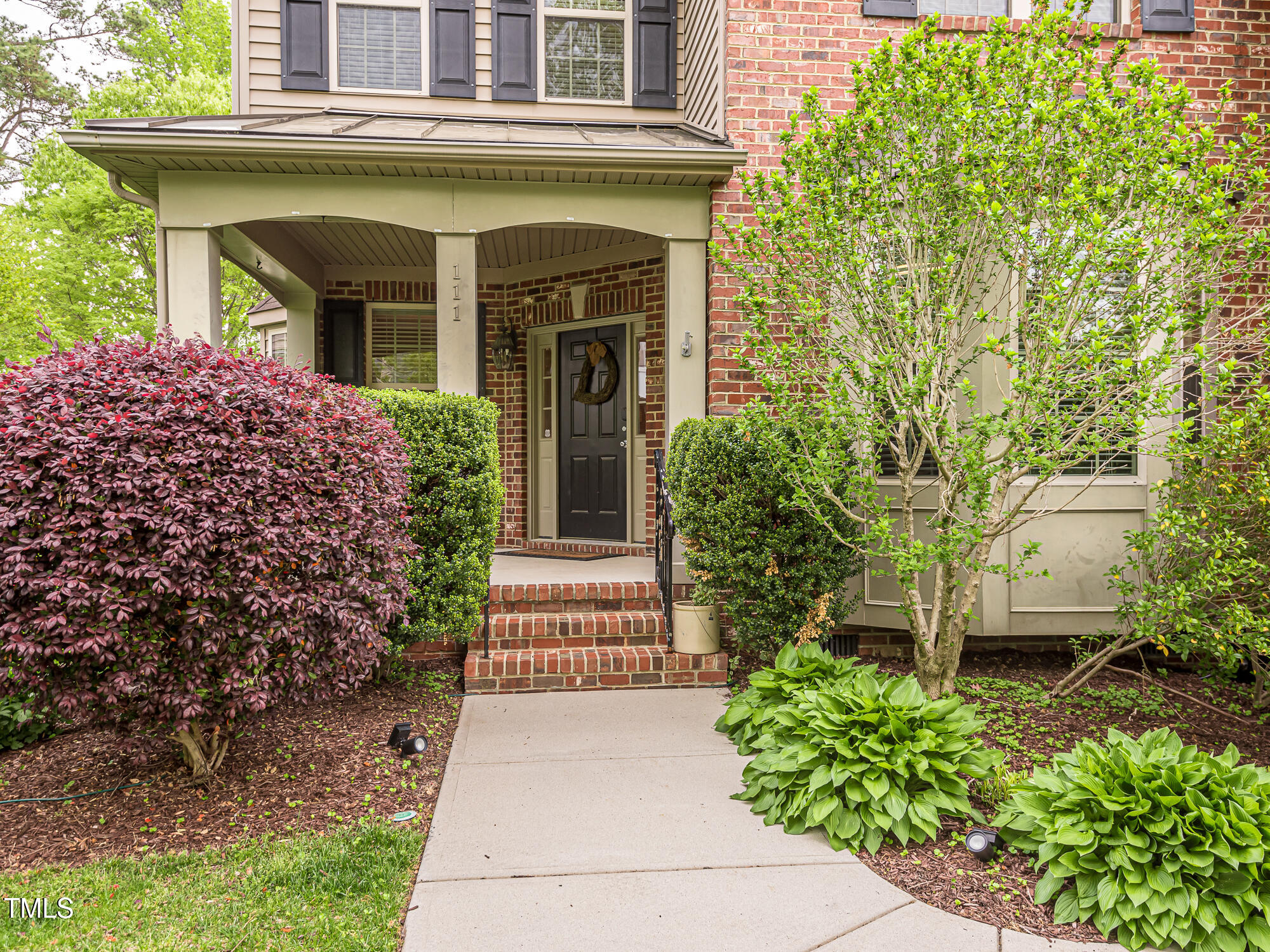 111 Gathering Place Durham, NC 27713 - Photo 36 of 44 a front view of a house with a garden