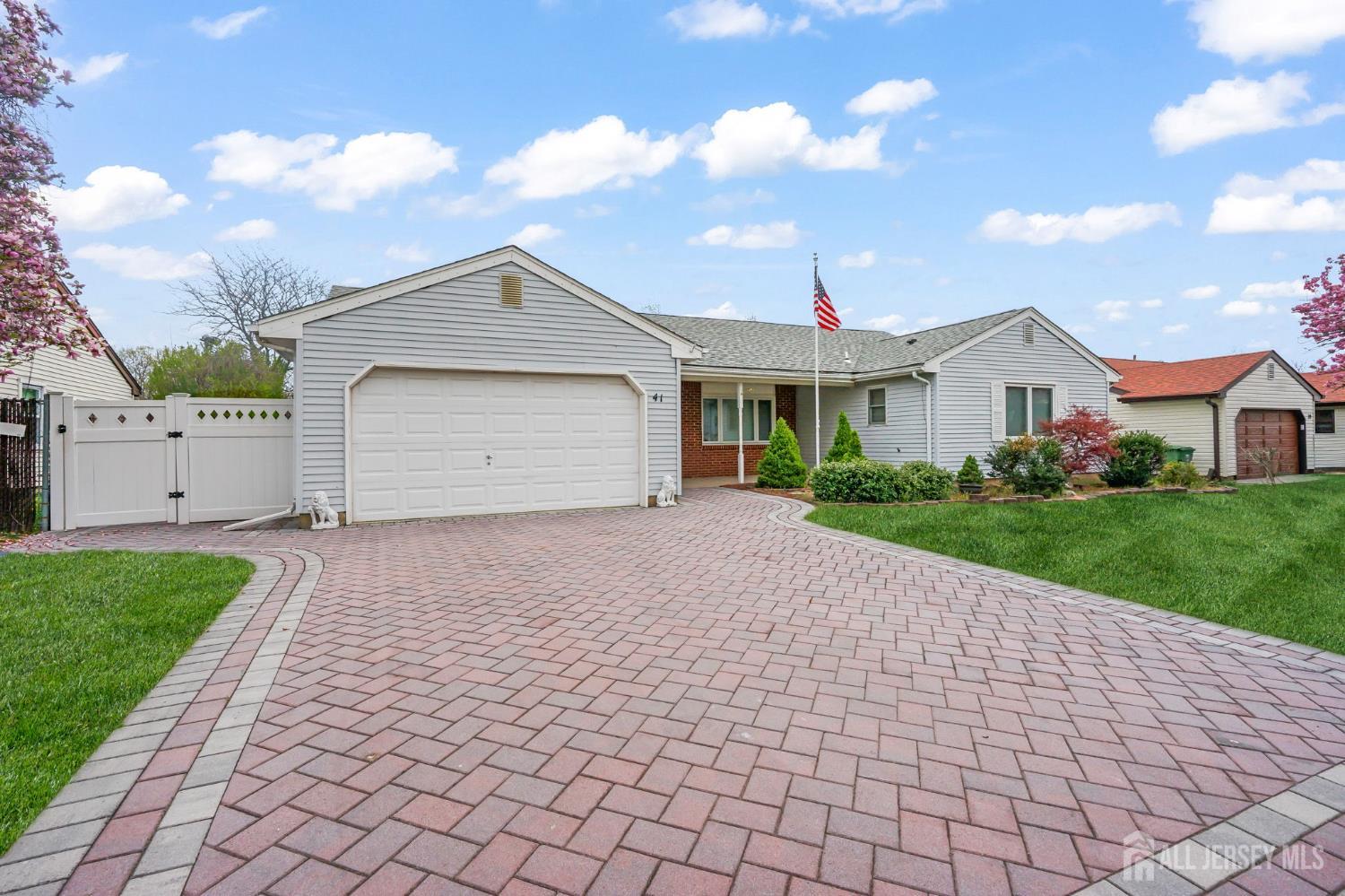 41 Rodak Circle Edison, NJ 08817 - Photo 2 of 28 a front view of a house with a yard and garage