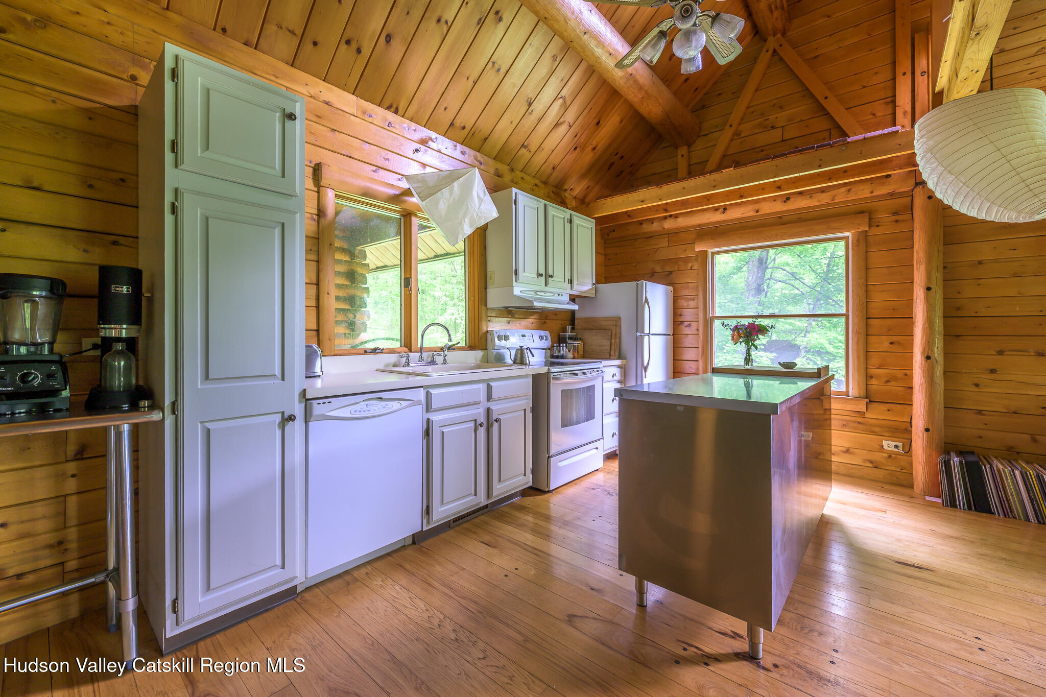 75 Upper Hollow Road Austerlitz, NY 12529 - Photo 15 of 21 a kitchen with stainless steel appliances granite countertop wooden floors wooden cabinets a dining table and chairs