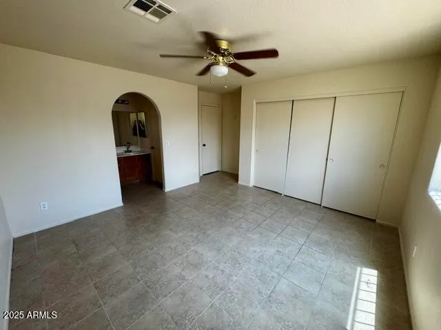 a view of an empty room with a ceiling fan