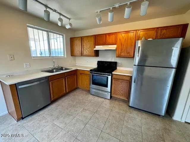 a kitchen with a sink appliances and cabinets