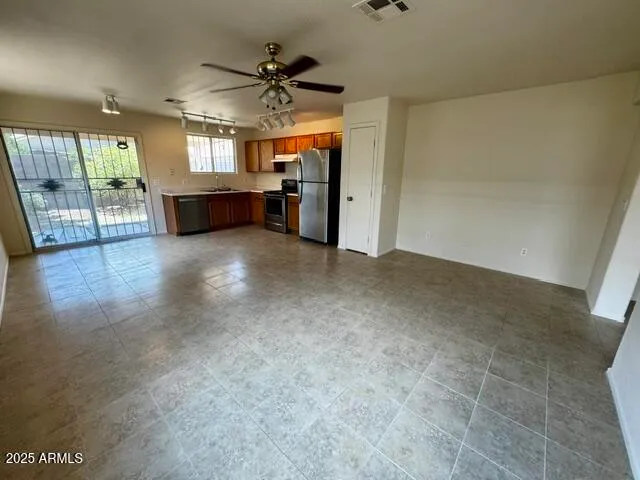 an empty room with fireplace and windows