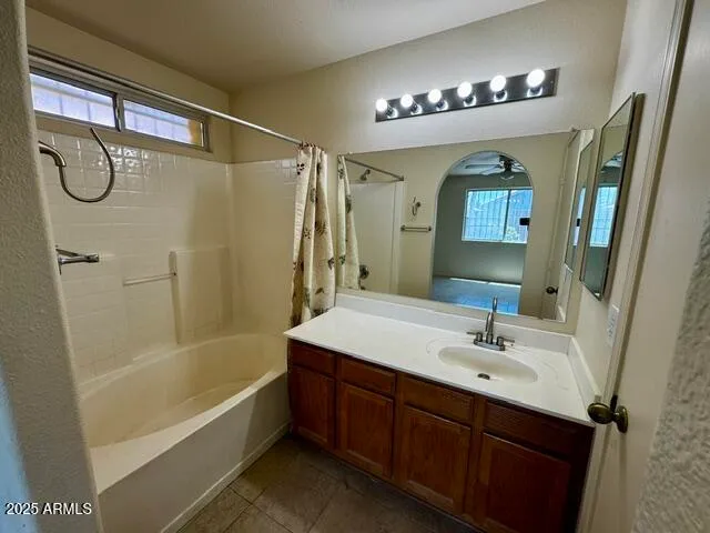 a bathroom with a tub a sink and a mirror