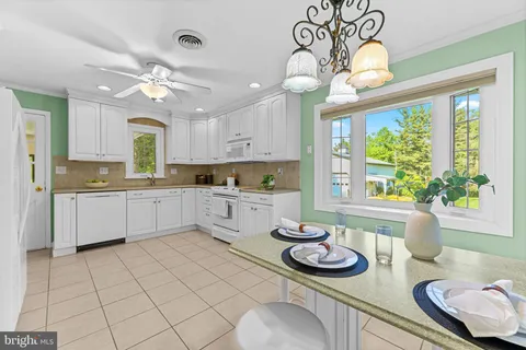 a kitchen with stainless steel appliances kitchen island granite countertop a sink and cabinets