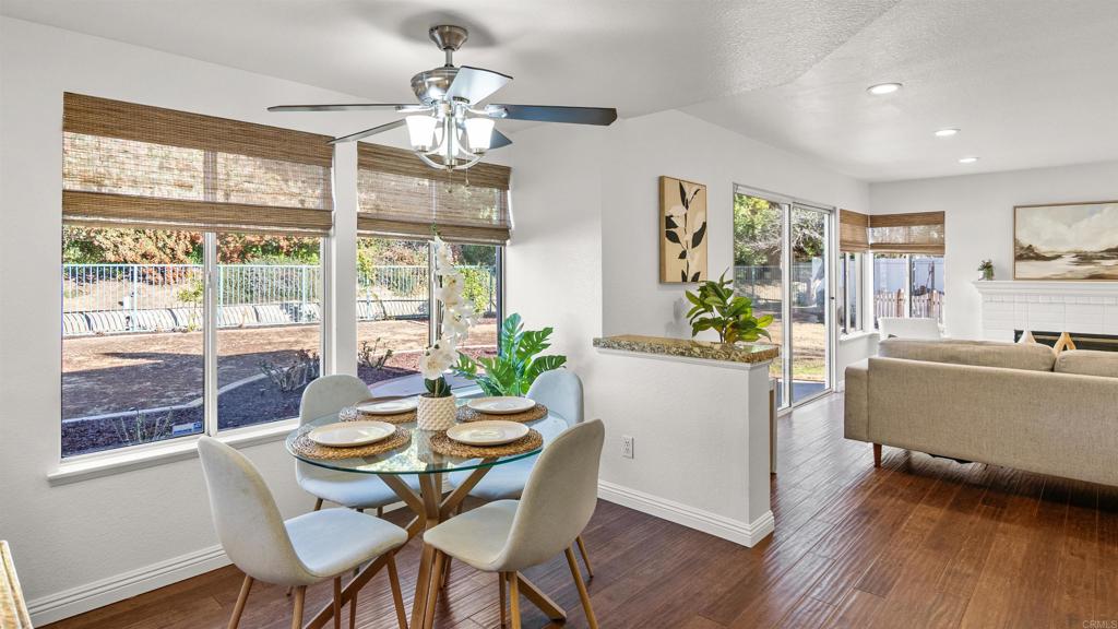 354 Lustrosos Street Oceanside, CA 92057 - Photo 21 of 75 a dining room with furniture a large window and wooden floor
