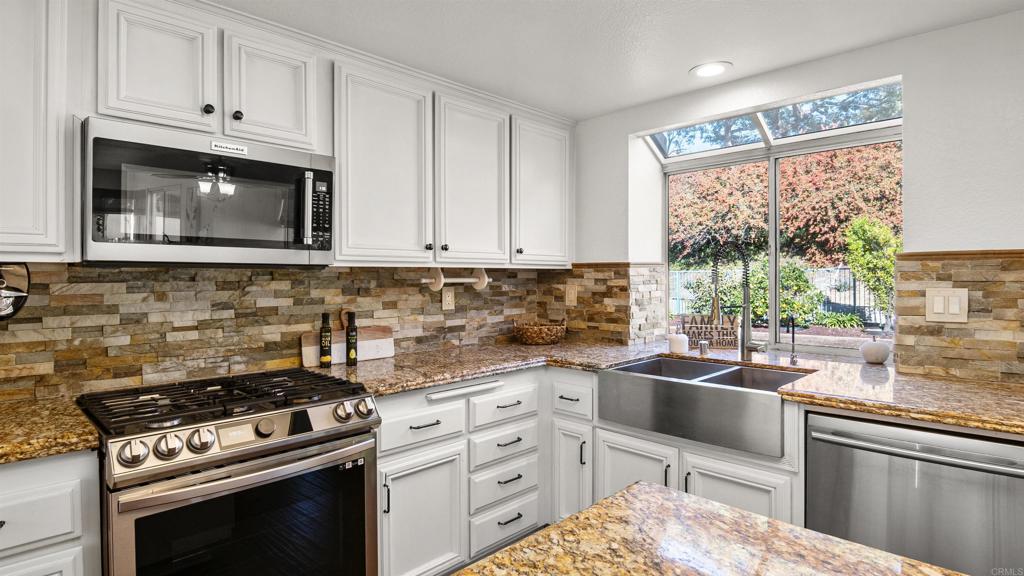 354 Lustrosos Street Oceanside, CA 92057 - Photo 26 of 75 a kitchen with cabinets appliances and a window