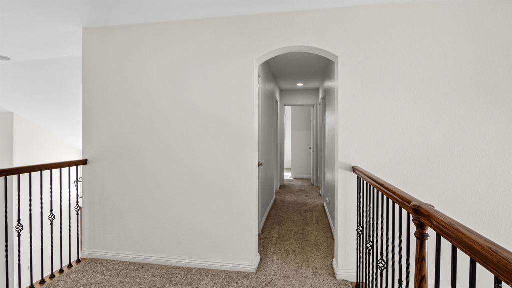 354 Lustrosos Street Oceanside, CA 92057 - Photo 30 of 75 a view of a hallway with wooden floor and staircase