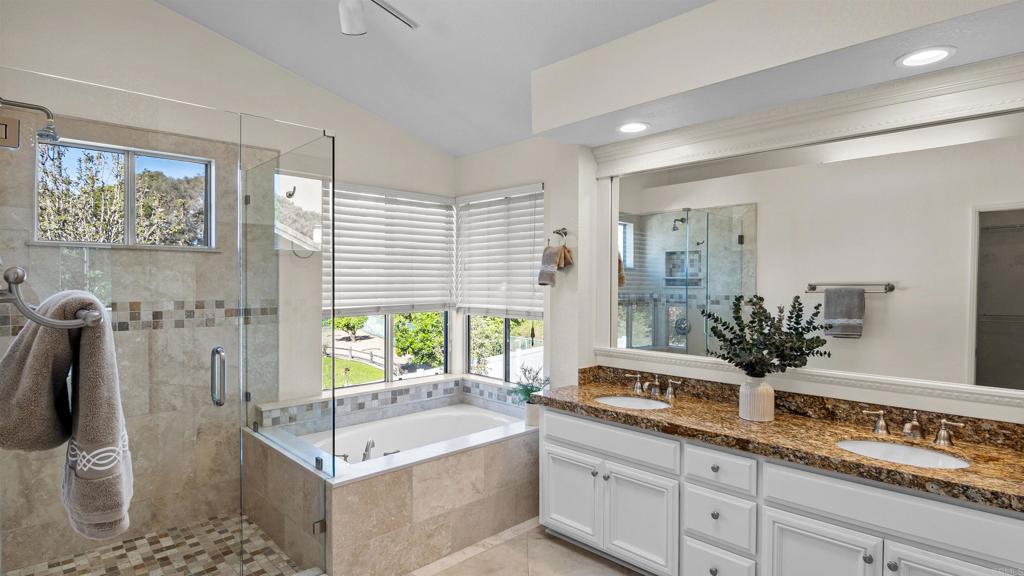 354 Lustrosos Street Oceanside, CA 92057 - Photo 35 of 75 a bathroom with a tub a sink and mirror