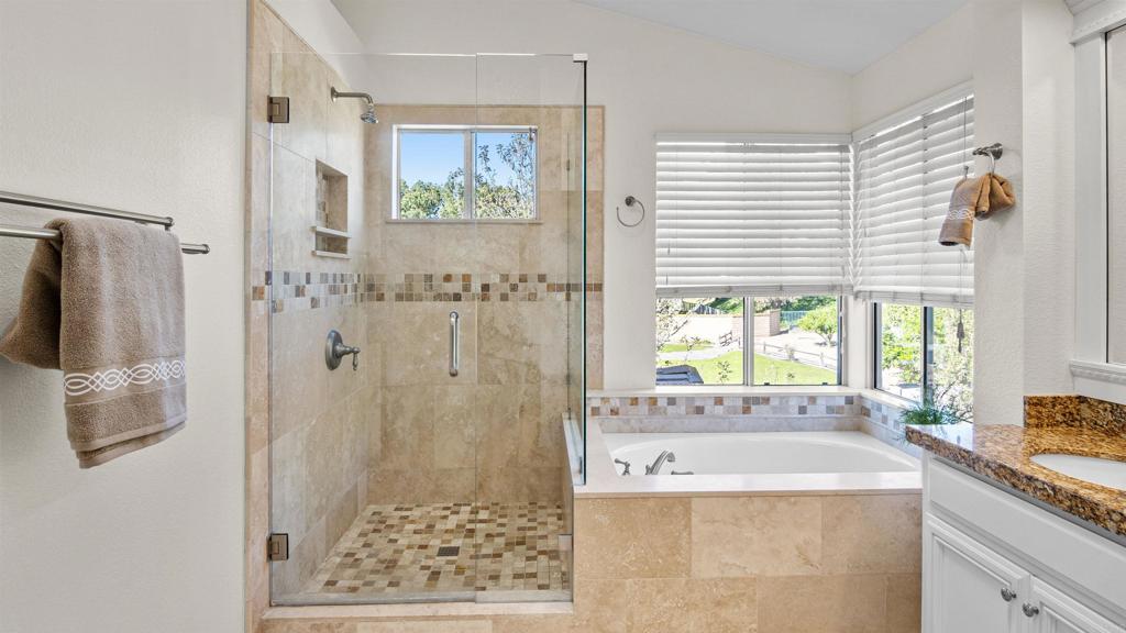 354 Lustrosos Street Oceanside, CA 92057 - Photo 36 of 75 a bathroom with a granite countertop sink a large mirror and a shower