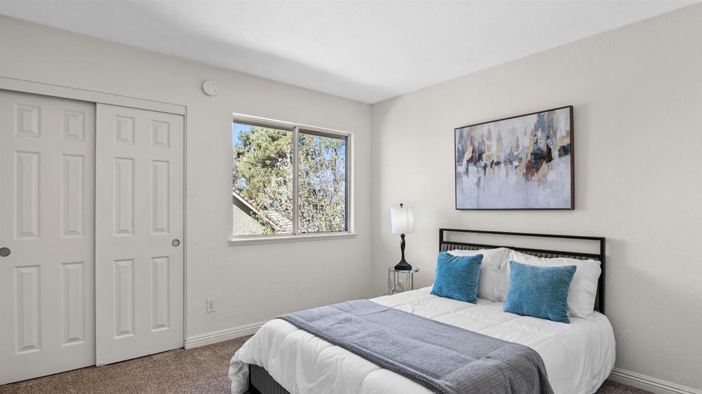 354 Lustrosos Street Oceanside, CA 92057 - Photo 39 of 75 a bedroom with a large bed and a window