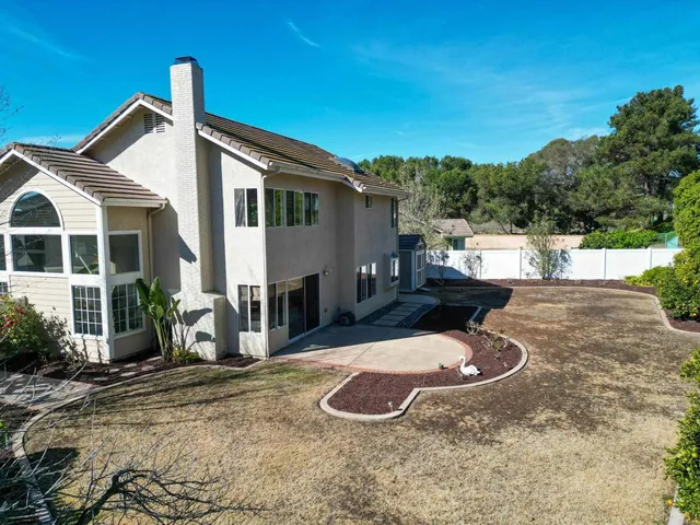 an aerial view of a house with garden space and street view