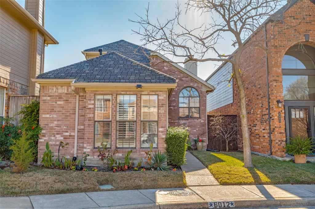 6012 Lloyd Court Dallas, TX 75252 - Photo 1 of 1 a front view of a house with garden