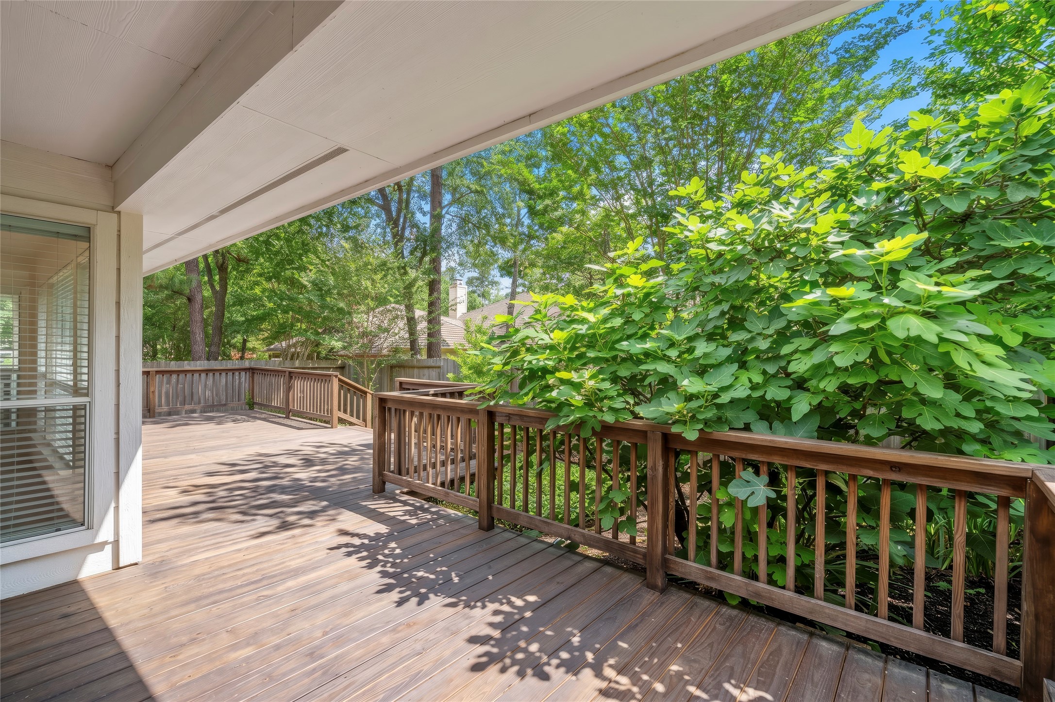 142 South Veranda Ridge Drive Spring, TX 77382 - Photo 25 of 31 Another view of the backyard deck surrounded by mature trees and lush landscaping, perfect for relaxing or entertaining outdoors.
