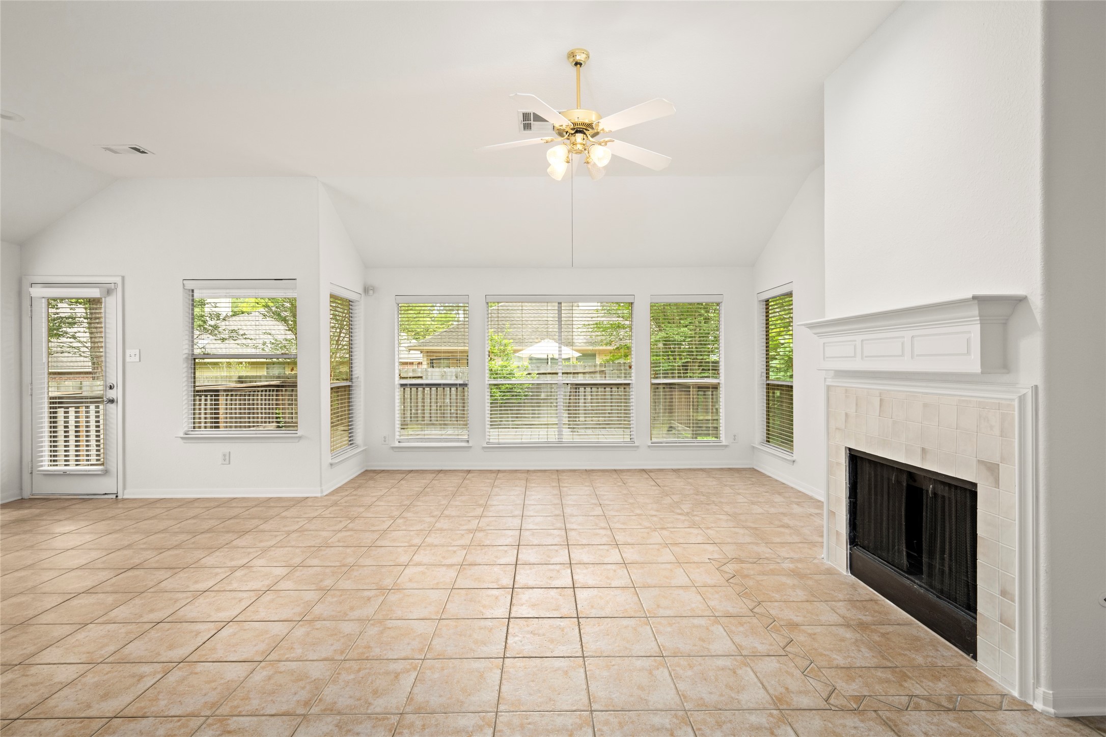 142 South Veranda Ridge Drive Spring, TX 77382 - Photo 3 of 31 With natural light spilling in from all directions, the spacious Living Room features tile, vaulted ceilings, a gas fireplace and a wall of windows that provides views of the back deck.