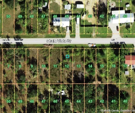 a front view of a building with a big yard and plants