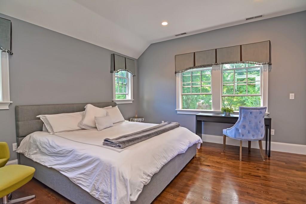 70 Arnold Road Newton, MA 02459 - Photo 24 of 39 a bedroom with a bed a table and a dresser next to a window