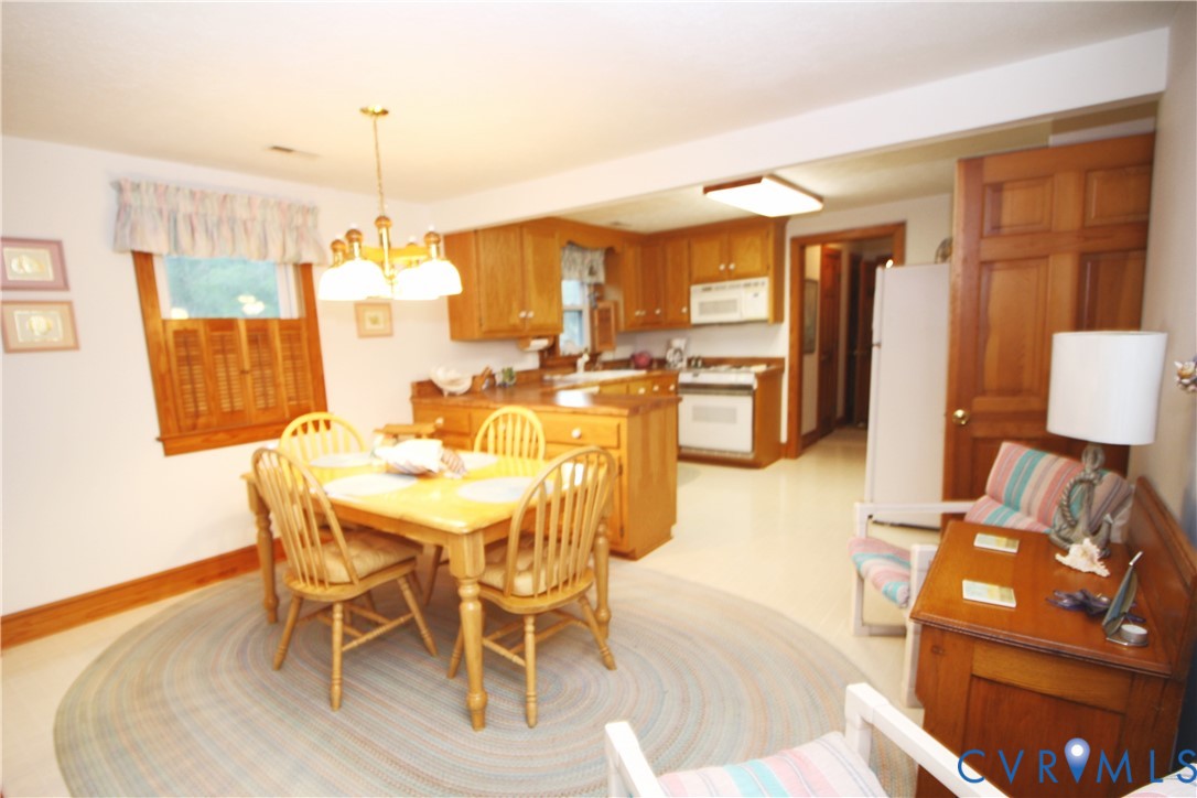 68 Springtide Lane Port Haywood, VA 23138 - Photo 12 of 33 a view of a dining room with furniture and chandelier