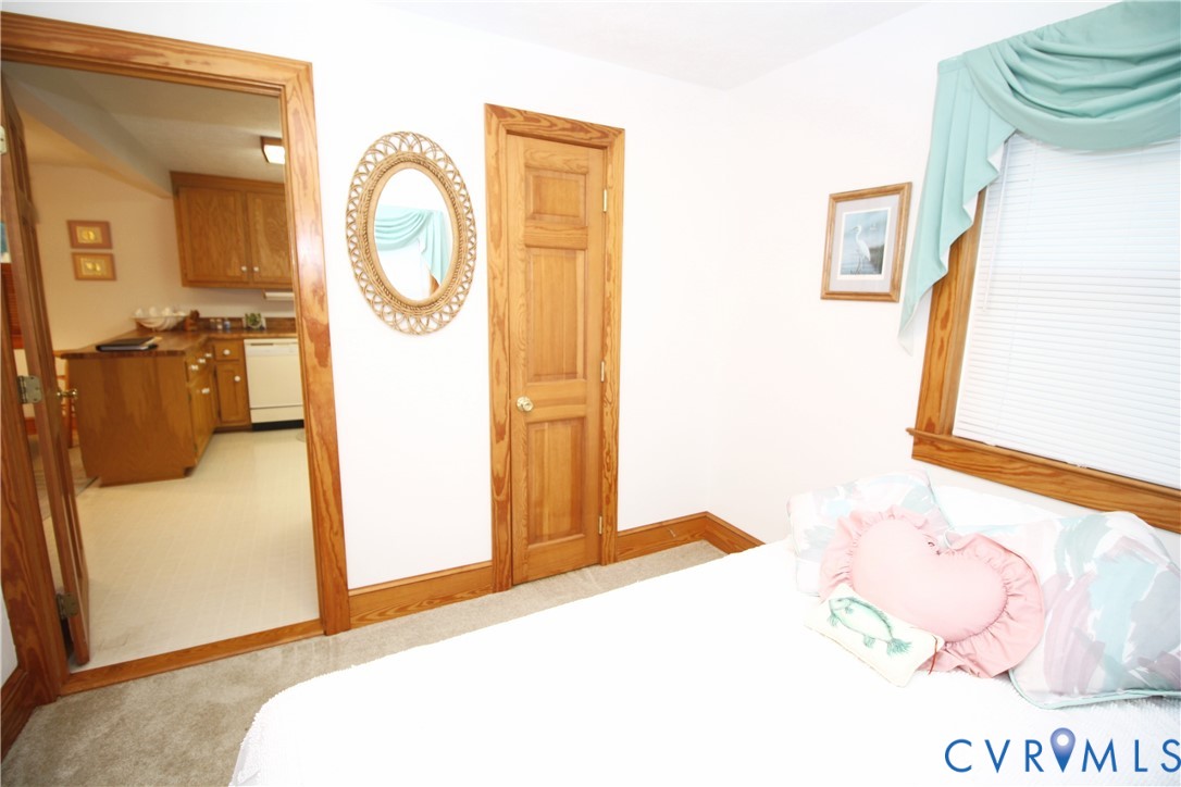 68 Springtide Lane Port Haywood, VA 23138 - Photo 18 of 33 a bedroom with a bed and a mirror