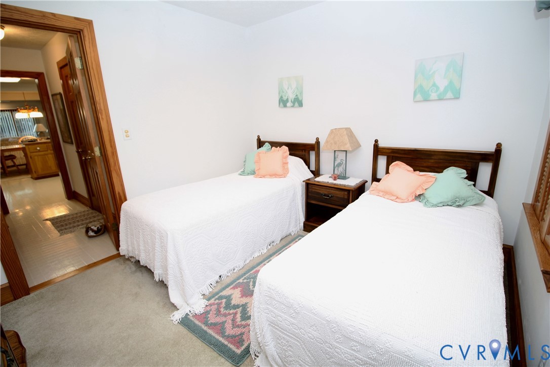 68 Springtide Lane Port Haywood, VA 23138 - Photo 21 of 33 a bedroom with two beds and painting on the wall