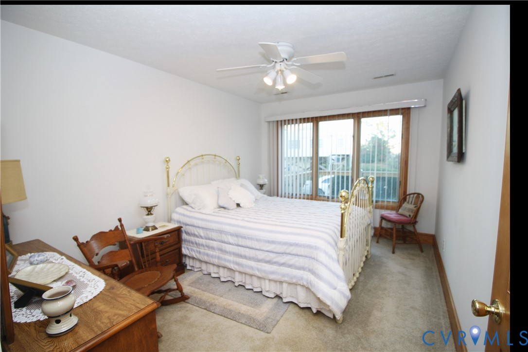 68 Springtide Lane Port Haywood, VA 23138 - Photo 23 of 33 a bedroom with a bed and glass window