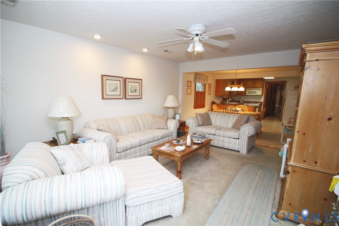 68 Springtide Lane Port Haywood, VA 23138 - Photo 7 of 33 a living room with furniture and a lamp